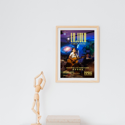 A framed concert poster for Lil.Lulu's 'First Date' acoustic live music show hangs on a white wall above a small wooden box, with a wooden mannequin figure standing to the left.